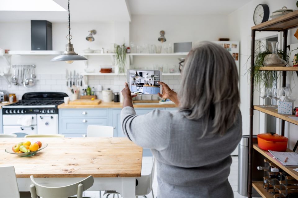 Baby boomer taking photo of interior home