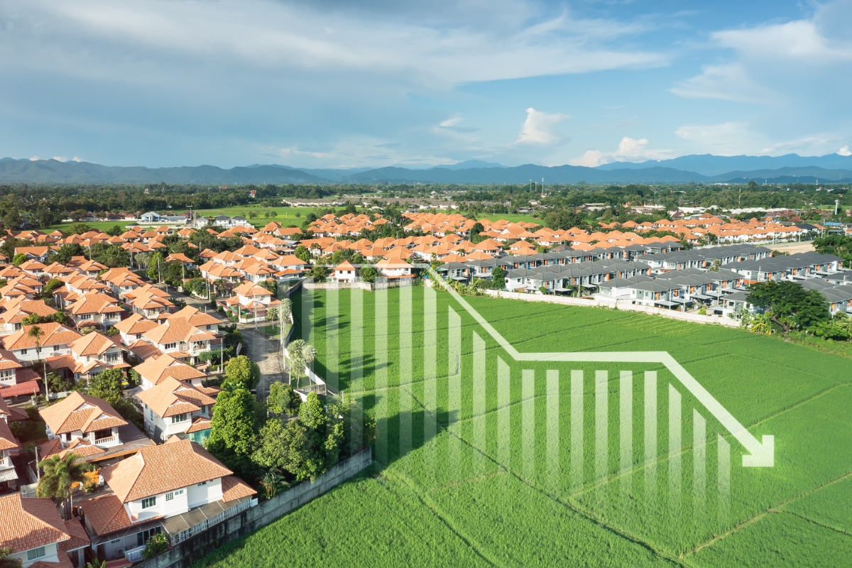 Aerial view of houses and a chart showing the shortage of homes